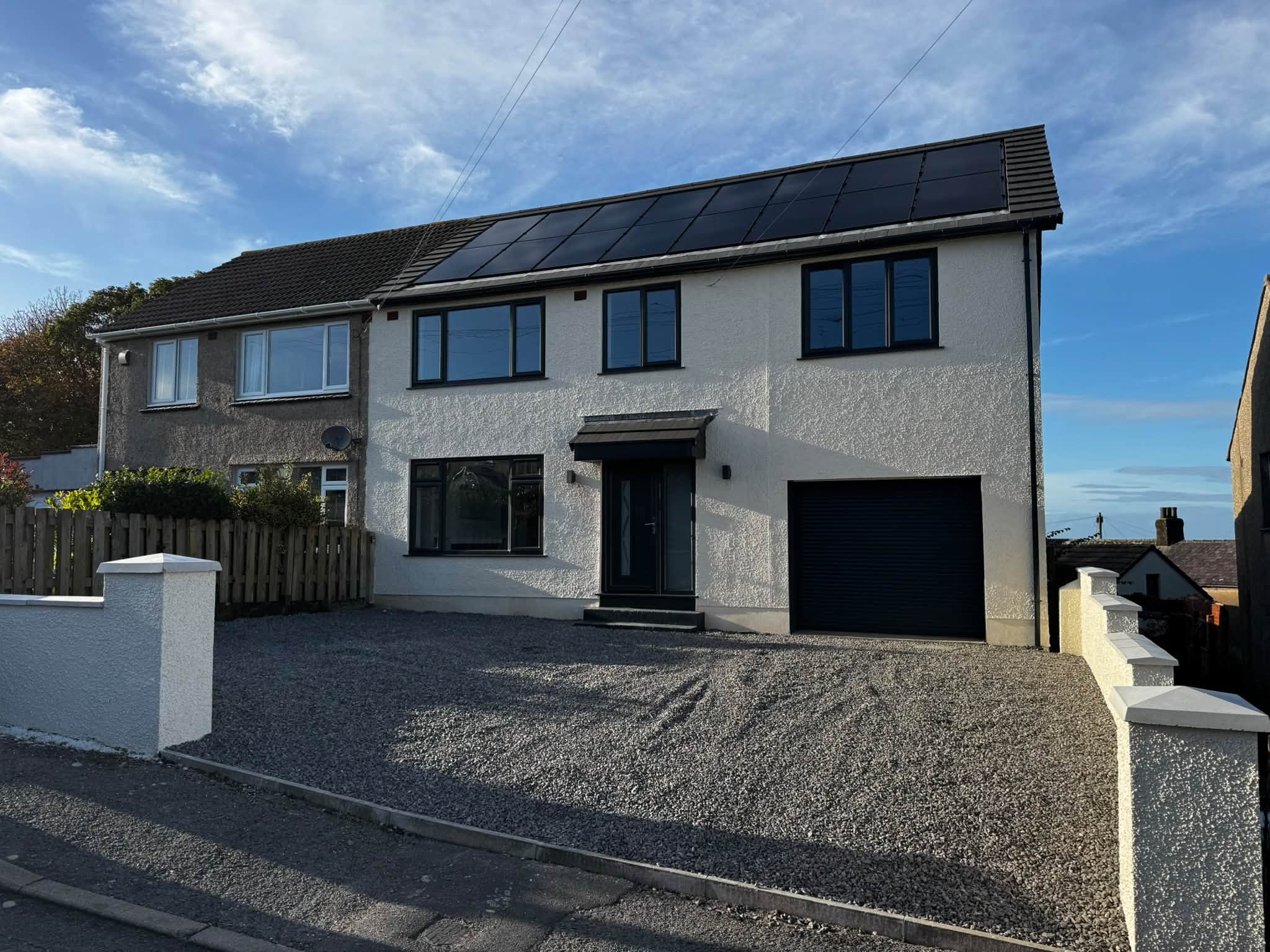 Renovated Harrington house front with new render, glazing and driveway