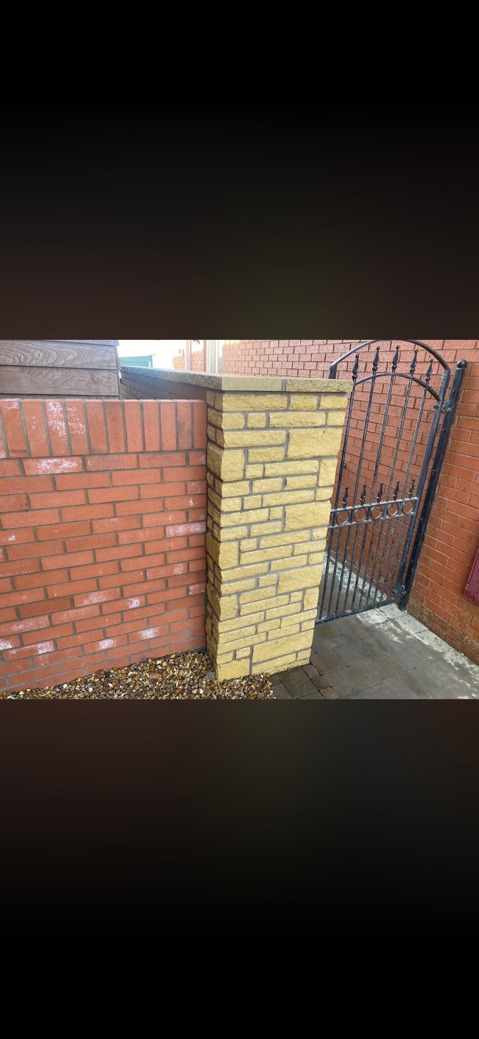 Stone pier with matching brick face and copings